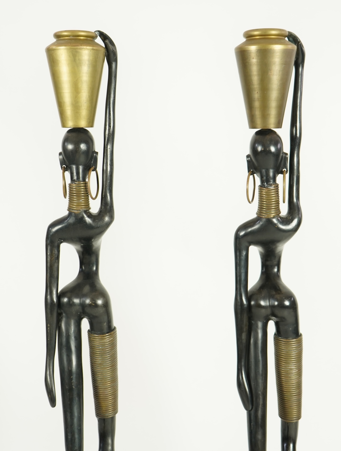 A large pair of Hagenauer style ebonised bronze 'Giraffe Woman' figures